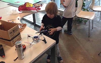 A pint-sized hacker works on a drone at last year's Geekcon Kids (Photo credit: Courtesy)