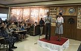 US President Barack Obama addresses troops at the US Marine Corps base in Kaneohe, Hawaii, as First Lady Michelle Obama looks on, December 25, 2014. (photo credit: AFP/Nicholas Kamm)
