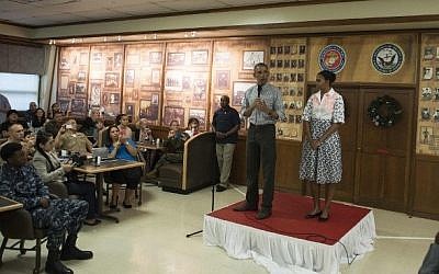 US President Barack Obama addresses troops at the US Marine Corps base in Kaneohe, Hawaii, as First Lady Michelle Obama looks on, December 25, 2014. (photo credit: AFP/Nicholas Kamm)