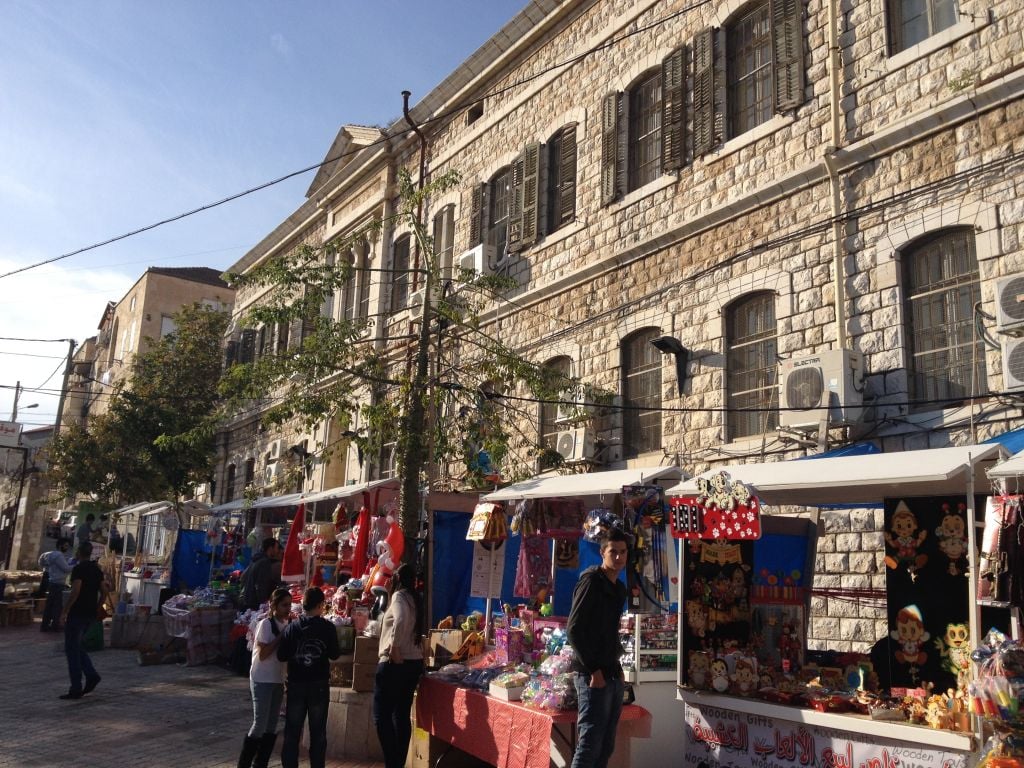 Kiosks selling everything from candied apples to Palestinian jewelry line the streets of Nazareth (photo credit: Jessica Steinberg/Times of Israel)