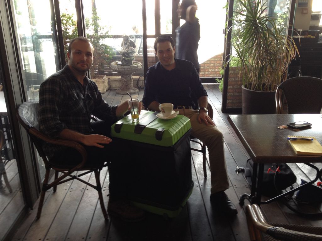 Daniel Gindis and Isaac Atlas, two of the Fugu founders, using a demo Fugu as a tabletop (photo credit: Jessica Steinberg/Times of Israel)