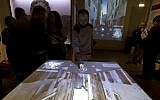 An interactive table shows a reconstruction of the Old Ghetto during its unveiling for the press in Rome's Jewish Museum, December 4, 2014. (photo credit: AP/Alessandra Tarantino)