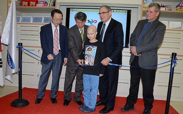 (L to R) Samsung Israel CEO Karyen Kai; South Korean ambassador to Israel Lee Gun-Tae; Or Wilhelm, a nine year old oncology patient at Schneider Children's Hospital; Professor Yosef Peres of Schneider Children's Hospital; and MK Miki Rosenthal (Photo credit: Aviv Hofi) (L to R) Samsung Israel CEO Karyen Kai; South Korean ambassador to Israel Lee Gun-Tae; Or Wilhelm, a nine year old oncology patient at Schneider Children's Hospital; Professor Yosef Peres of Schneider Children's Hospital; and MK Miki Rosenthal (Photo credit: Aviv Hofi)