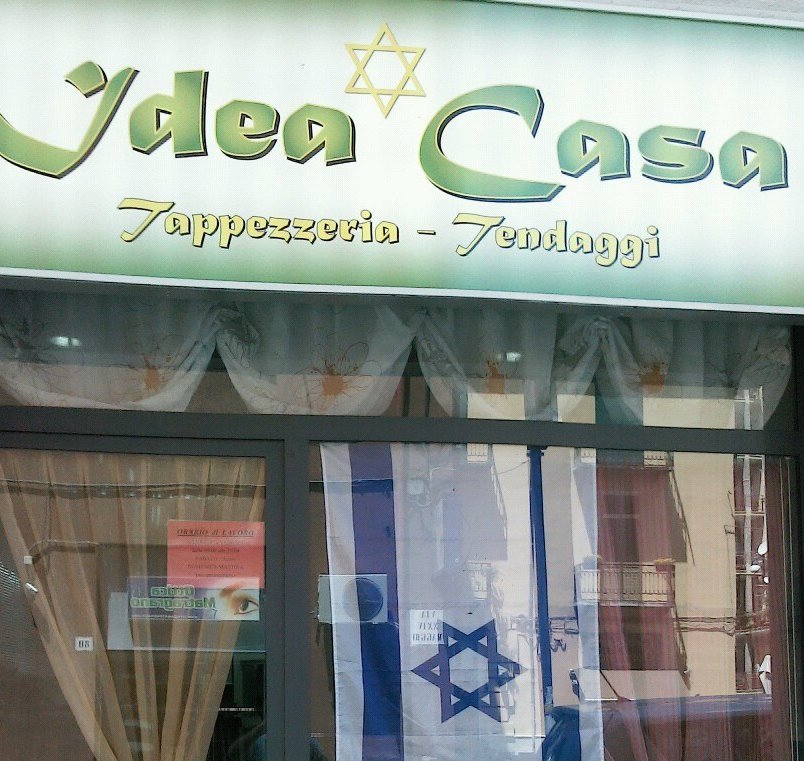 Antonio Calabrese's upholstery shop is adorned by a Star of David on its sign. He added the Israeli flag after the three murdered Israeli teens' bodies were discovered last summer. (courtesy) Antonio Calabrese's upholstery shop is adorned by a Star of David on its sign. He added the Israeli flag after the three murdered Israeli teens' bodies were discovered last summer. (courtesy)