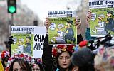 Femen activists hold Charlie Hebdo frontpages during a Unity rally on January 11, 2015 in Paris in tribute to the 17 victims of a three-day killing spree by homegrown Islamists. (photo credit: AFP/LOIC VENANCE)