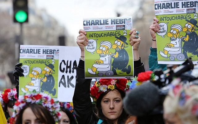 Femen activists hold Charlie Hebdo frontpages during a Unity rally “Marche Republicaine” on January 11, 2015 at the Place de la Republique (Republique's square) in Paris in tribute to the 17 victims of a three-day killing spree by homegrown Islamists. (photo credit: AFP/LOIC VENANCE) Femen activists hold Charlie Hebdo frontpages during a Unity rally “Marche Republicaine” on January 11, 2015 at the Place de la Republique (Republique's square) in Paris in tribute to the 17 victims of a three-day killing spree by homegrown Islamists. (photo credit: AFP/LOIC VENANCE)
