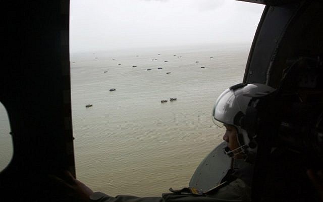 An Indonesian crew of navy aircraft CN 235 checks the situation during searching for the missing airline AirAsia QZ8501 in Karimata Strait, January 3, 2015 (photo credit: AFP) An Indonesian crew of navy aircraft CN 235 checks the situation during searching for the missing airline AirAsia QZ8501 in Karimata Strait, January 3, 2015 (photo credit: AFP)