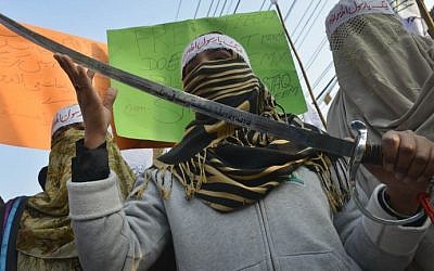 A Pakistan woman demonstrator holds a sword during a protest against the printing of satirical sketches of the Prophet Muhammad by French magazine Charlie Hebdo, in Lahore on January 20, 2015. photo credit: Arif Ali/AFP)