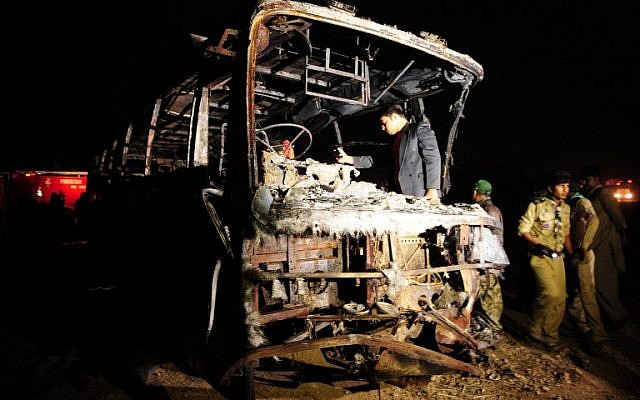 Pakistani volunteers search for victims inside a burnt out passenger bus after it collided with an oil tanker along the Super Highway near Karachi early on January 11, 2015. (photo credit: AFP/Asif HASSAN) Pakistani volunteers search for victims inside a burnt out passenger bus after it collided with an oil tanker along the Super Highway near Karachi early on January 11, 2015. (photo credit: AFP/Asif HASSAN)