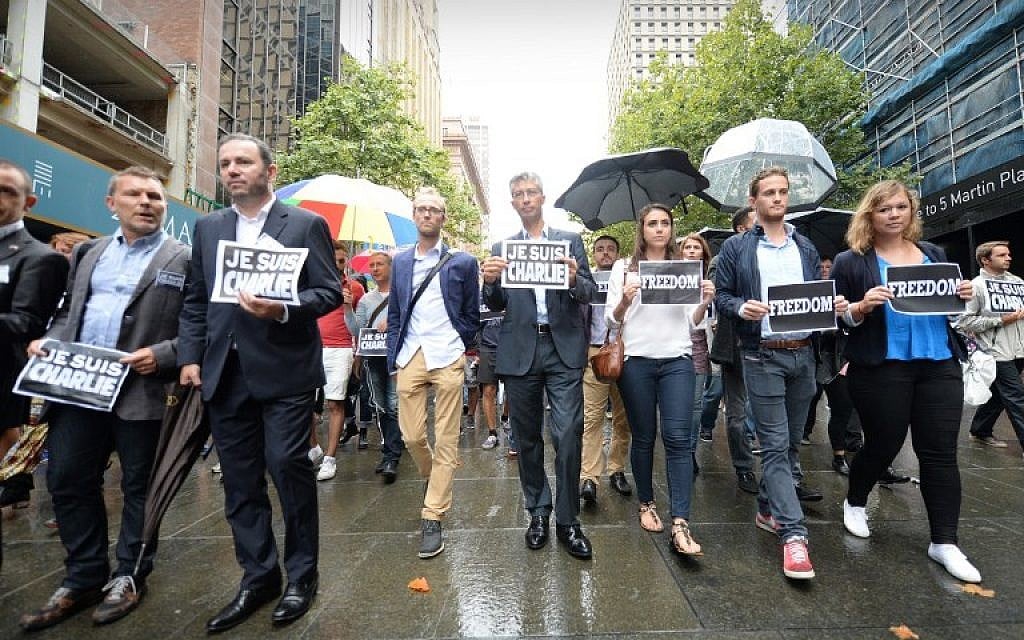 French ambassador to Australia Christophe Lecourtier (2nd L) leads members of Sydney's French community in the heart of the city to pay tribute to the Paris jihadist attack victims, near the scene of a deadly cafe siege last month in Sydney, on January 11, 2015. (photo credit: AFP PHOTO/Peter PARKS)