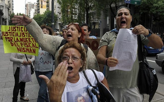 A woman holds a sign reading 'Justice, justice, justice for the death of prosecutor Nisman' during a demonstration in front of the National Congress in Buenos Aires on January 19, 2015. (photo credit: AFP/Juan Vargas) A woman holds a sign reading 'Justice, justice, justice for the death of prosecutor Nisman' during a demonstration in front of the National Congress in Buenos Aires on January 19, 2015. (photo credit: AFP/Juan Vargas)