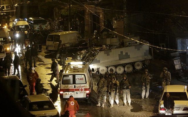 Lebanese security forces and emergency personnel gather outside a cafe targeted by a suicide bombing on January 10, 2015 in the Jabal Mohsen Alawite neighbourhood of the northern city of Tripoli. (photo credit: AFP/IBRAHIM CHALHOUB) Lebanese security forces and emergency personnel gather outside a cafe targeted by a suicide bombing on January 10, 2015 in the Jabal Mohsen Alawite neighbourhood of the northern city of Tripoli. (photo credit: AFP/IBRAHIM CHALHOUB)
