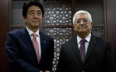 Japan's Prime Minister Shinzo Abe meets with Palestinian president Mahmoud Abbas at the Palestinian Authority's headquarters in Ramallah on January 20, 2015. (photo credit: Nasser Nassr/AFP) 
