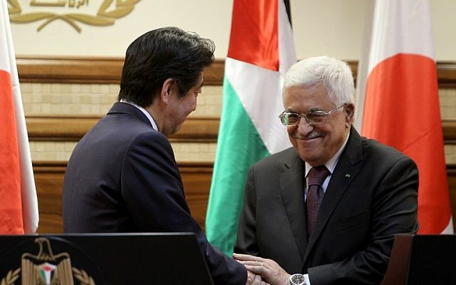 Japan's Prime Minister Shinzo Abe (L) shakes hands with Palestinian Authority President Mahmoud Abbas during a press conference on January 20, 2015, in the West Bank city of Ramallah. (photo credit: AFP PHOTO / ABBAS MOMANI) Japan's Prime Minister Shinzo Abe (L) shakes hands with Palestinian Authority President Mahmoud Abbas during a press conference on January 20, 2015, in the West Bank city of Ramallah. (photo credit: AFP PHOTO / ABBAS MOMANI)