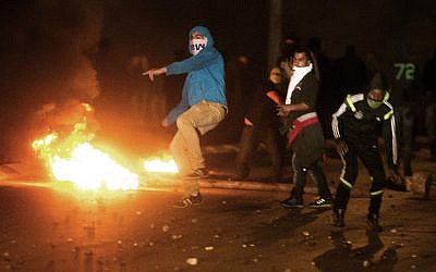 Protesters clash with Israeli police (unseen) in the southern Israeli Bedouin city of Rahat on January 20, 2015. (photo credit: AFP/Menahem Kahana)