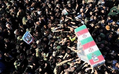 Iranian mourners carry the coffin of Brigadier General Mohammad Ali Allahdadi, a commander of the Islamic republic's Revolutionary Guards killed in an Israeli air strike on the weekend on Syria, during his funeral procession in Tehran on January 21, 2015.  (Photo credit: AFP/ATTA KENARE)