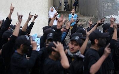 Palestinian youth, who are participating in a Hamas military-style camp, chant slogans as they march during a protest rally in support of the Prophet Mohammed in Gaza City on January 27, 2015. (Mahmud Hams/AFP)