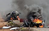 Israeli military vehicles are seen burning following a Hezbollah missile strike across the border on January 28, 2015. Two IDF soldiers were killed in the attack. (AFP/MARUF KHATIB)
