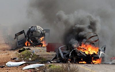 Israeli military vehicles are seen burning following a Hezbollah missile strike across the border on January 28, 2015. Two IDF soldiers were killed in the attack. (AFP/MARUF KHATIB)