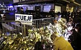 People place candles on January 10, 2015 during a demonstration at the end of Shabbat called by the Jewish Student's Union of France at the Porte de Vincennes in eastern Paris in homage to the four victims of the January 9, 2015 attack at a kosher supermarket in the French capital. (photo credit: AFP/KENZO TRIBOUILLARD)