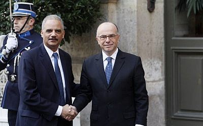 French Interior Minister Bernard Cazeneuve (R) welcomes US Attorney General Eric Holder prior to an International meeting against terrorism on January 11, 2015 at the Interior Ministry in Paris.  (AFP/MATTHIEU ALEXANDRE) 