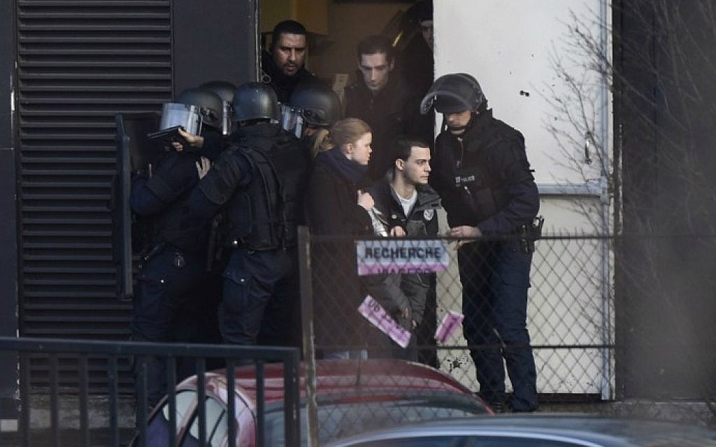 French police special forces evacuate residents in Porte de Vincennes, eastern Paris, after a gunman opened fire at a kosher grocery store, January 9, 2015. (photo credit: AFP/Martin Bureau)