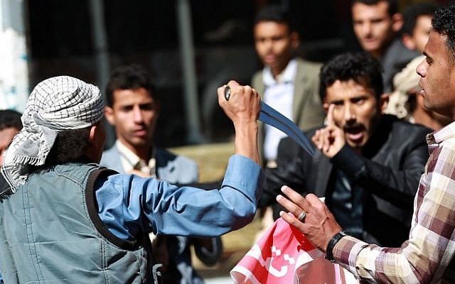 A Shiite Houthi rebel threatens Yemeni protesters during a rally against the control of the capital by Houthi rebels on January 24, 2015 in the capital Sanaa. (Photo credit: AFP / MOHAMMED HUWAIS) A Shiite Houthi rebel threatens Yemeni protesters during a rally against the control of the capital by Houthi rebels on January 24, 2015 in the capital Sanaa. (Photo credit: AFP / MOHAMMED HUWAIS)