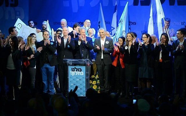 Kulanu party leader Moshe Kahlon surrounded by the party's Knesset candidates at a campaign kickoff event in Givat Brenner, January 15, 2015 (photo credit: courtesy/Facebook)