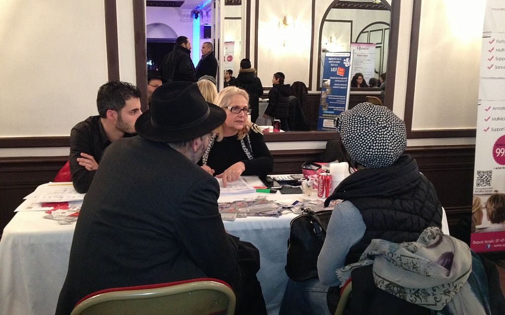 A Jewish couple discusses immigration to Israel with representatives of the Jewish Agency in Paris, January 11, 2015 (photo credit: Elhanan Miller/Times of Israel) A Jewish couple discusses immigration to Israel with representatives of the Jewish Agency in Paris, January 11, 2015 (photo credit: Elhanan Miller/Times of Israel)