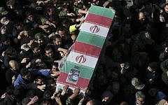 Illustrative: Civilians and members of the armed forces carry the flag draped coffin of Iranian Revolutionary Guard Brig. Gen. Mohammad Ali Allahdadi during his funeral ceremony outside the Guard compound in Tehran, Iran, January 21, 2015 (photo credit: AP/Vahid Salemi)