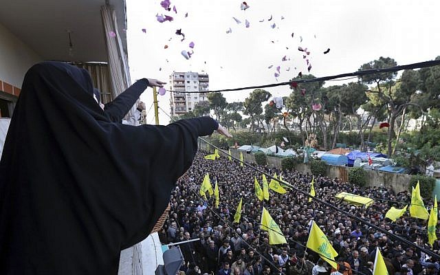 Lebanese women throw flowers on January 19, 2015 as Hezbollah supporters carry the coffin of Jihad Mughniyeh, the son of Imad Mughniyeh, who was killed in the air strike on the Syrian side of the Golan Heights (photo credit: AP/Bilal Hussein) Lebanese women throw flowers on January 19, 2015 as Hezbollah supporters carry the coffin of Jihad Mughniyeh, the son of Imad Mughniyeh, who was killed in the air strike on the Syrian side of the Golan Heights (photo credit: AP/Bilal Hussein)