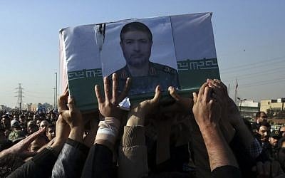 Civilians and armed forces members carry the coffin of Iranian Revolutionary Guard Brig. Gen. Mohammad Ali Allahdadi in his funeral ceremony outside the Guard compound in Tehran, Iran, Wednesday, Jan. 21, 2015 (photo credit: AP/Vahid Salemi)