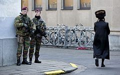 Belgian para-commandos patrol near a synagogue in the center of Antwerp, Belgium, on Saturday, Jan. 17, 2015. (photo credit: AP/Virginia Mayo)
