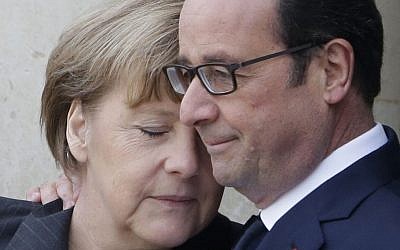 French President Francois Hollande embraces German Chancellor Angela Merkel, left, as she arrives at the Elysee Palace, Paris, Sunday, Jan. 11, 2015. (photo credit: AP/Thibault Camus)