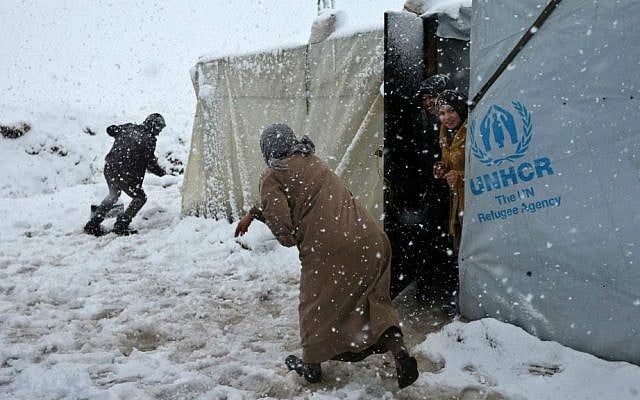 Syrians throw snow at each other at a refugee camp in Deir Zannoun village, in the Bekaa valley, east Lebanon, Wednesday, Jan. 7, 2015. (AP Photo/Hussein Malla)