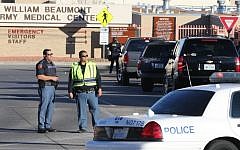 Police officers guard an entrance to the Beaumont Army Medical Center/El Paso VA campus during the search for a gunman Tuesday, Jan. 6, 2014. (Photo credit: AP/The El Paso Times, Victor Calzada)