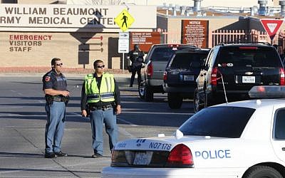 Police officers guard an entrance to the Beaumont Army Medical Center/El Paso VA campus during the search for a gunman Tuesday, Jan. 6, 2014. (Photo credit: AP/The El Paso Times, Victor Calzada)