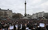 People stand for a memorial gathering for the victims of the recent terrorist attacks in France, held in Trafalgar Square, London, Sunday, Jan. 11, 2015. (photo credit: AP/Tim Ireland)