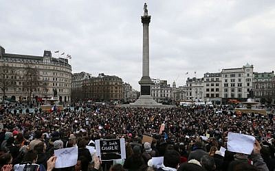 People stand for a memorial gathering for the victims of the recent terrorist attacks in France, held in Trafalgar Square, London, Sunday, Jan. 11, 2015. (photo credit: AP/Tim Ireland) 