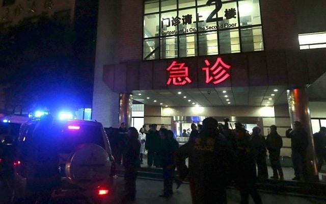 In this photo released by China's Xinhua News Agency, medical workers stand outside the emergency ward of the No. 1 People's Hospital of Shanghai after a stampede caused casualties among people who took part in New Year's celebrations in Shanghai, early on Thursday, Jan. 1, 2015. (Photo credit: AP/Xinhua, Ding Ting)