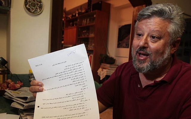 Gershon Baskin holds the draft agreement between Israel and Hamas for the release of Gilad Shalit at his home in Jerusalem, October 12, 2011 photo credit: Kobi Gideon/Flash90