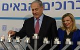 Too much? An article attacks Sara Netanyahu for being mean to house staff. In this photo Benjamin and Sara Netanyahu light candles during the Jewish holiday of Hanukkah in December 2014. (photo credit; Amos Ben Gershon/GPO)