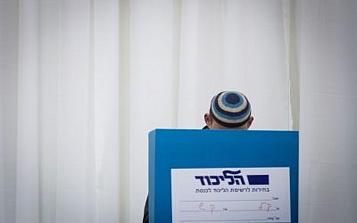 A Likud member casts his vote in the party primaries in Jerusalem, December 31, 2014. (photo credit: Miriam Alster/Flash90)