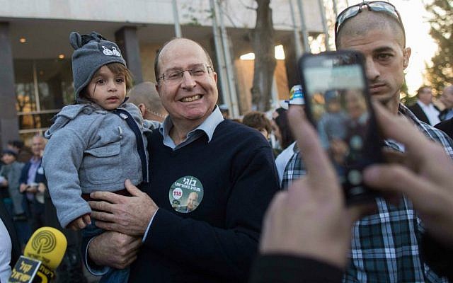 Defense Minister Moshe Ya'alon with supporters outside a Likud primary polling station in Jerusalem, December 31, 2014. (photo credit: Yonatan Sindel/Flash90)