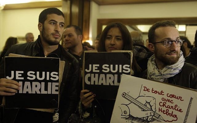 People hold signs that read 'Je suis Charlie' ('I am Charlie' at a solidarity rally at the French ambassador's residence in Jaffa, Israel, on January 8, 2015. (photo credit: Amir Levy/Flash90) People hold signs that read 'Je suis Charlie' ('I am Charlie' at a solidarity rally at the French ambassador's residence in Jaffa, Israel, on January 8, 2015. (photo credit: Amir Levy/Flash90)