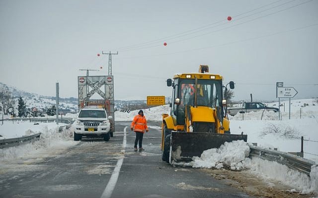 A tractor removes snow from the road in the Golan Heights on January 8, 2015. Photo by Basal Awidat/FLASH90. A tractor removes snow from the road in the Golan Heights on January 8, 2015. Photo by Basal Awidat/FLASH90.