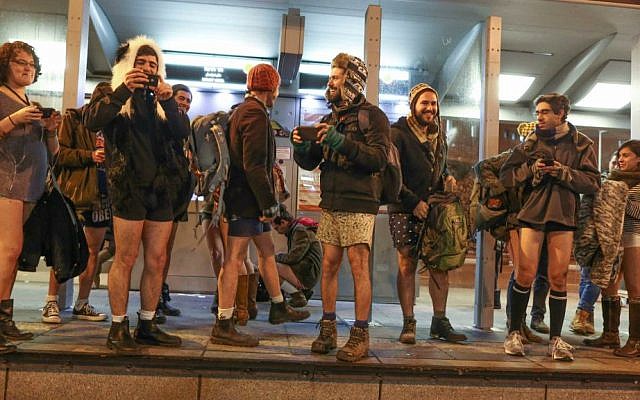 Pantless Jerusalem light rail riders wait for train. No Pants Train Ride, January 11, 2015. (Nati Shohat/Flash 90)