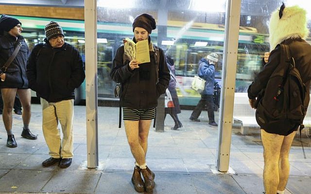 Pantless Jerusalem light rail riders wait for train. No Pants Train Ride, January 11, 2015. (Nati Shohat/Flash 90)
