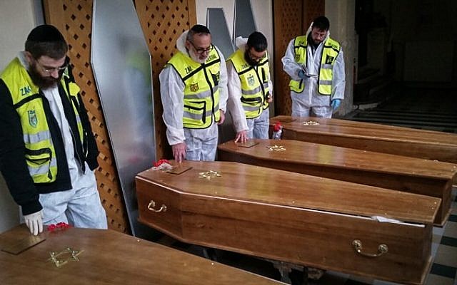 Zaka medical volunteers with the caskets of the four Jewish victims of the Paris Kosher Market terror attack, after having finished preparing the bodies for buriel, January 12, 2015 (Photo credit: Zaka Spokesperson/Flash90) Zaka medical volunteers with the caskets of the four Jewish victims of the Paris Kosher Market terror attack, after having finished preparing the bodies for buriel, January 12, 2015 (Photo credit: Zaka Spokesperson/Flash90)