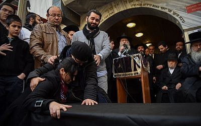 A mourner at the Jerusalem funeral for four Jewish victims of the Paris terror attacks, on January 13, 2015.  (photo credit: Ben Kelmer/Flash90)